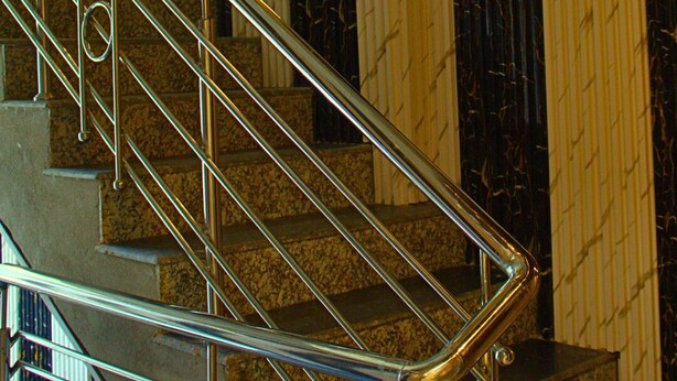 A staircase with metal railings and a patterned wall in the background. - GANGA RIVERFRONT ROOMS AND BANQUET (Prayagraj)