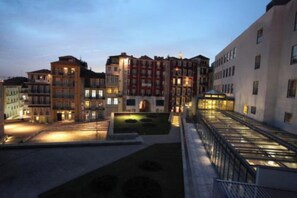 Stunning multi-story building with a mix of modern and traditional architecture, featuring a beautifully maintained courtyard.