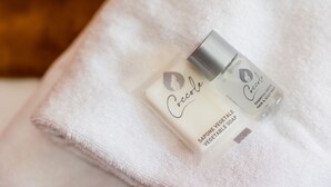 Two bottles of Coccie soap on a white towel.