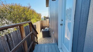 A wooden deck leading to a building with a door and a lantern. - Disney SoFi Stadium Hollywood Beaches Close! Central AC (Norwalk)