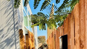 A narrow pathway flanked by wooden fences leading to a set of stairs. - Disney SoFi Stadium Hollywood Beaches Close! Central AC (Norwalk)