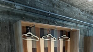 A wardrobe with a geometric wood pattern and three white hangers. - Re PORT HOTEL (Yaizu)