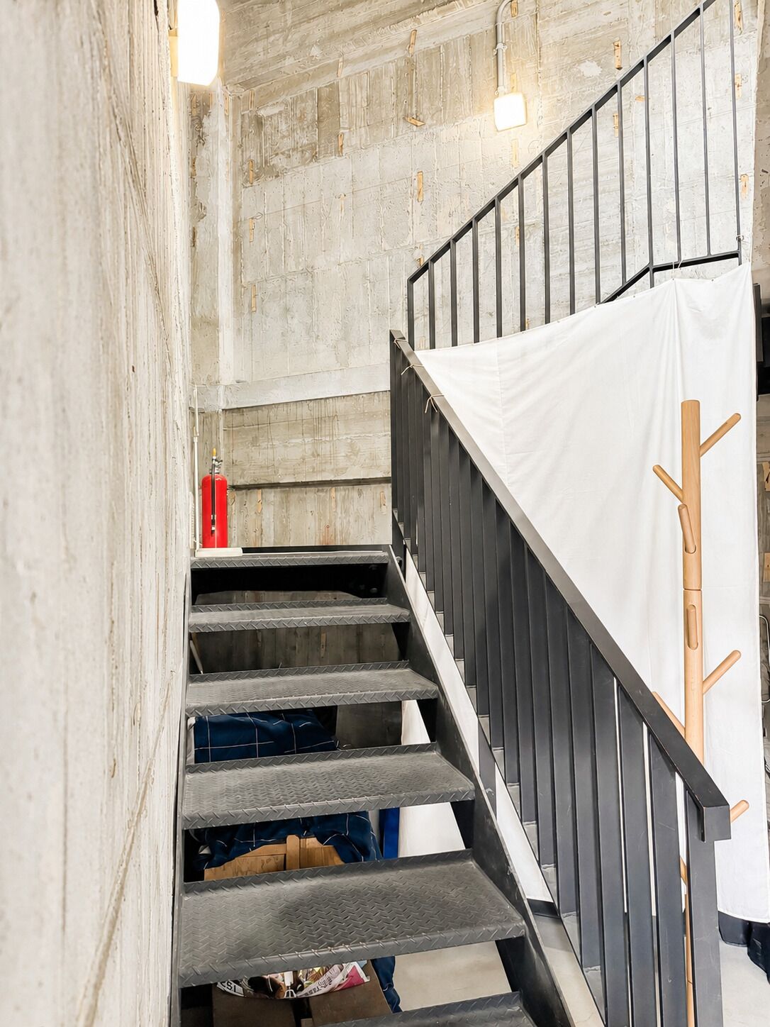 A staircase with a metal railing and a white cloth draped over it.