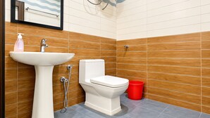 A bathroom with a sink, toilet, and shower.