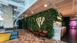 A modern lobby with a green wall, wooden ceiling, and herringbone patterned floor. - Student only Premium Studio at Lewisham Exchange (London)