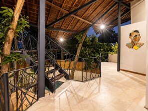 A modern outdoor staircase with metal railings, surrounded by greenery and a wooden ceiling structure. - Chic 2-BR Villa with Pool, 800m to Canggu Beach (Kecamatan Mengwi)