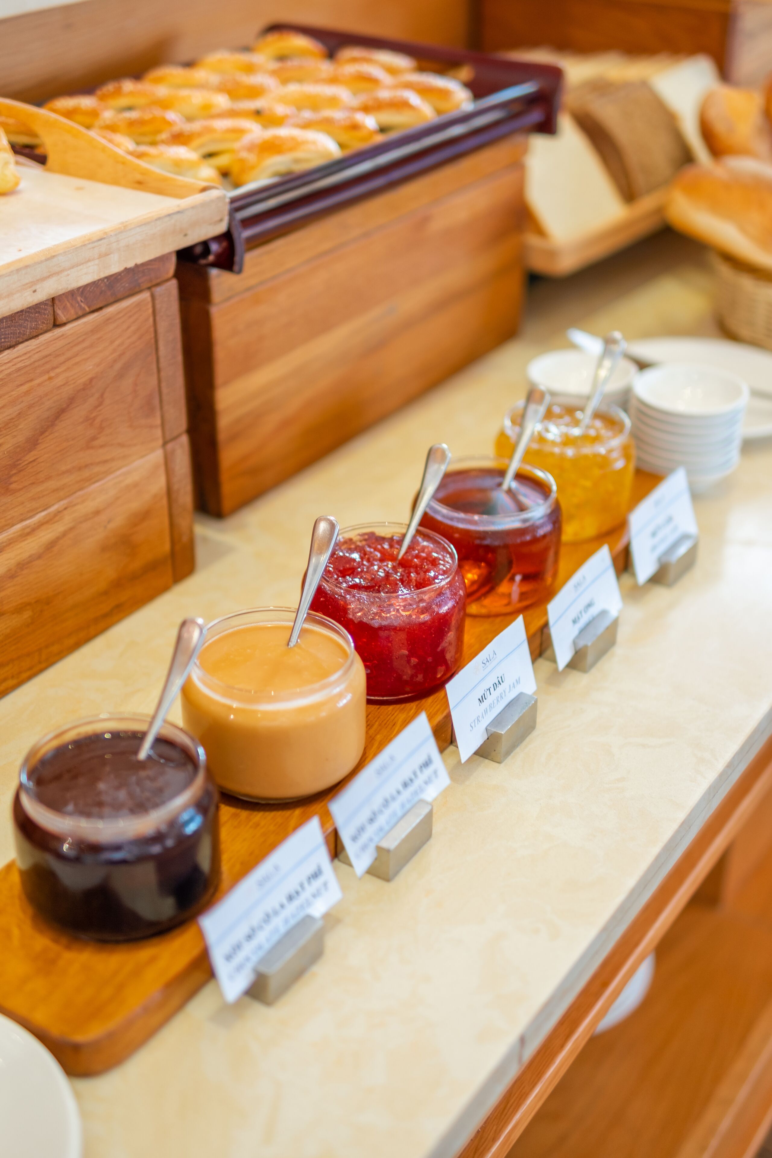 A buffet with various food items and condiments.