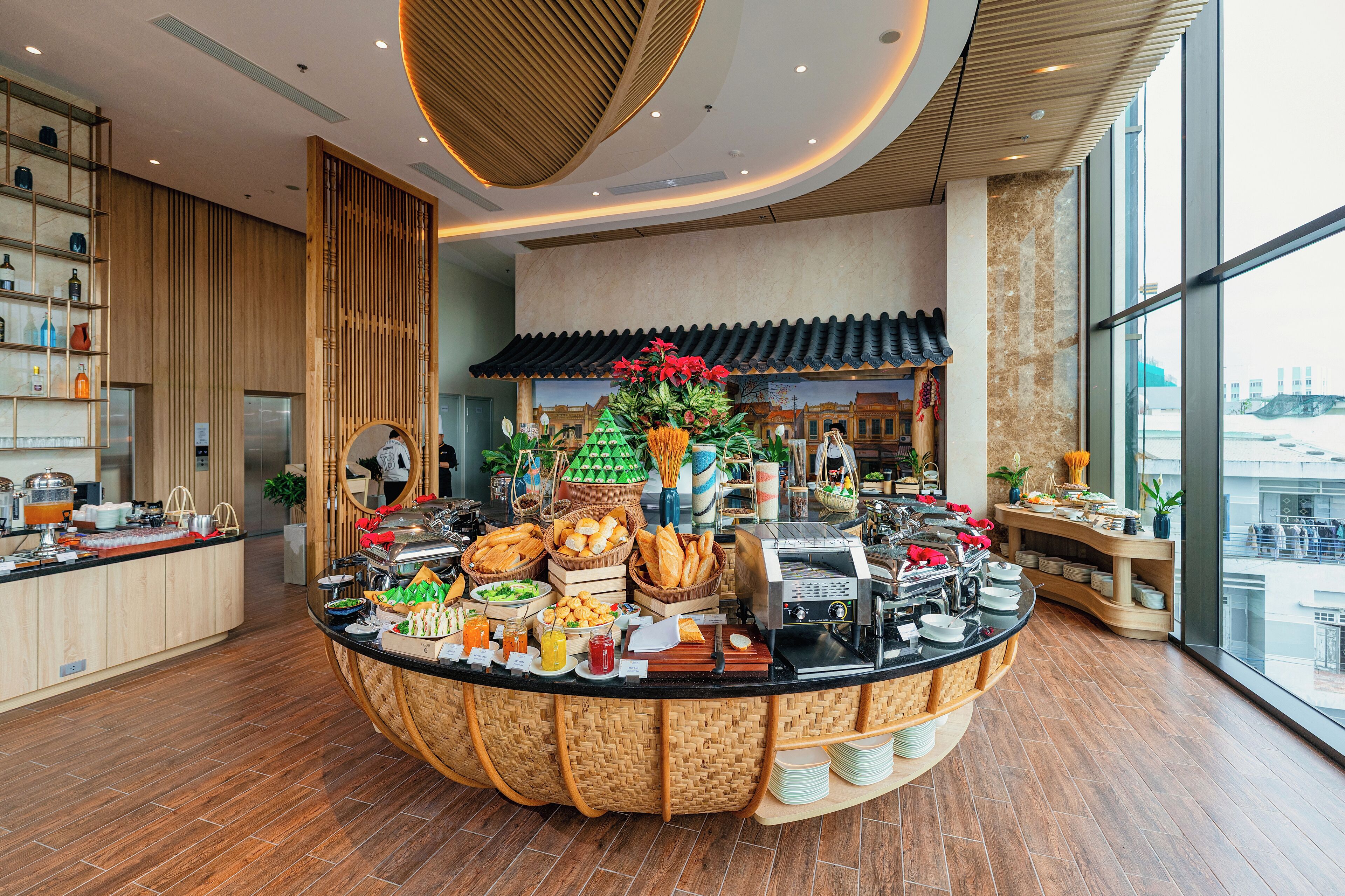 A buffet setup with various food items and a traditional decor.