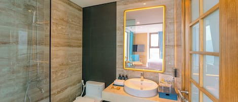 A modern bathroom with a glass shower enclosure, a white toilet, a sink with a mirror, and a towel rack.