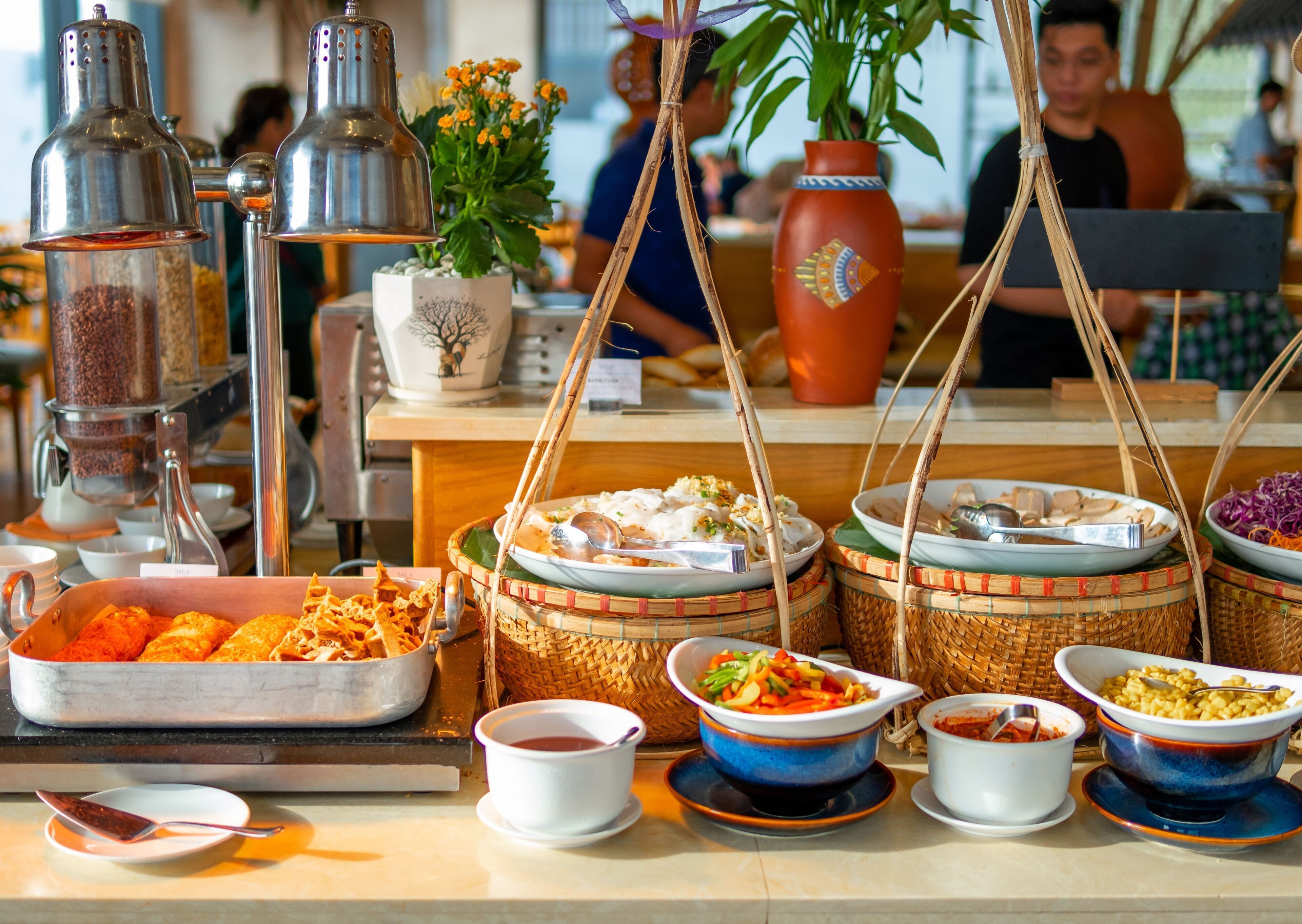 A buffet with various dishes and condiments.