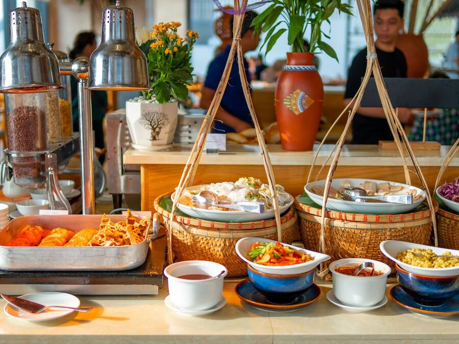 A buffet with various dishes and condiments.