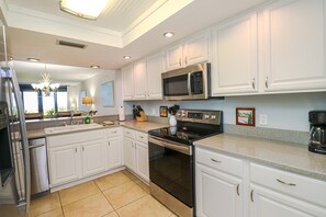 Fridge, microwave, oven, stovetop - Barefoot 113 - RENO PROJECT - 2 Bedroom/2 Bathroom ocean front condo steps away (St. Augustine)