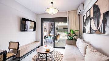 Deluxe Apartment, 1 Bedroom, Poolside | Living area | Flat-screen TV