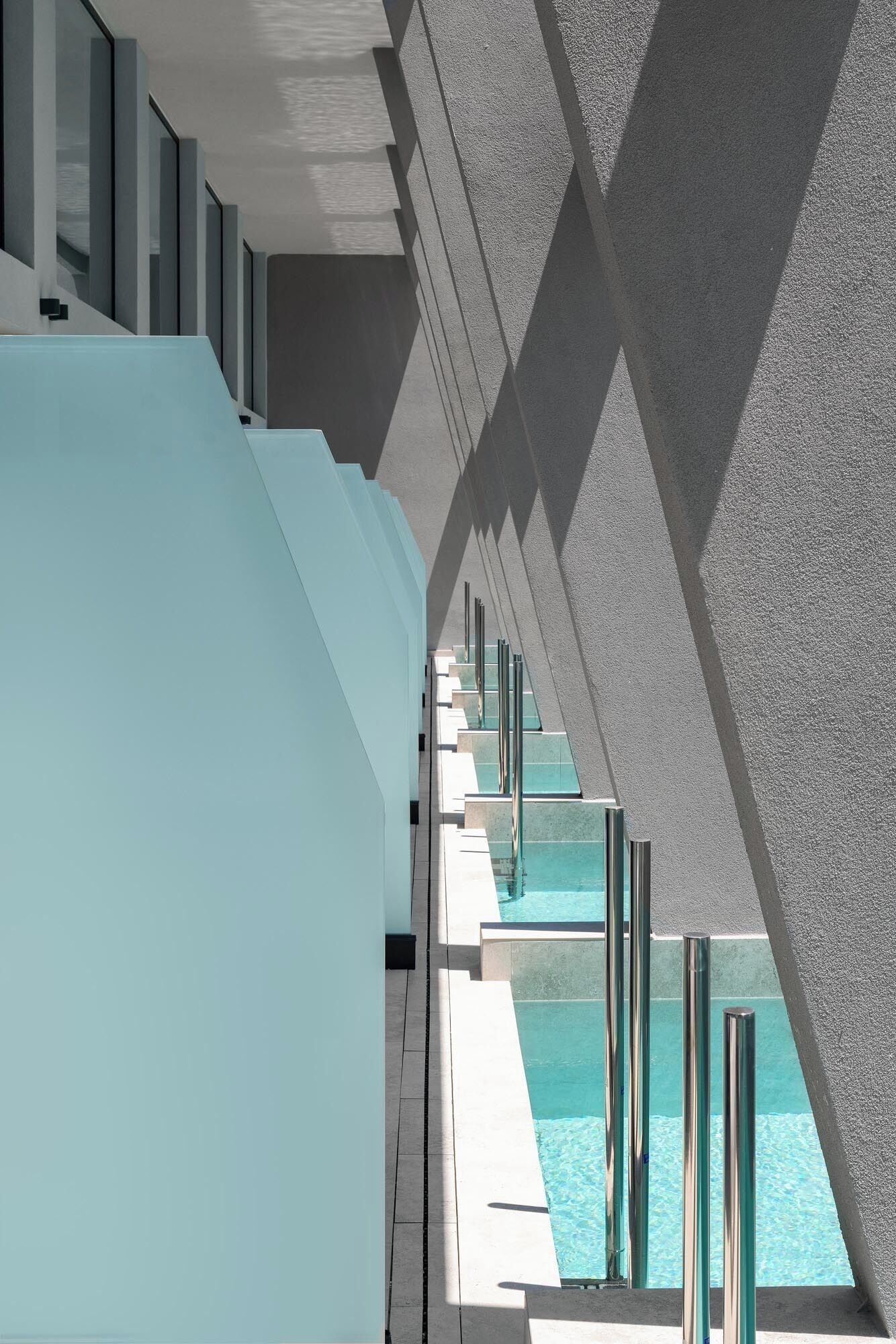 A modern architectural design with a pool area, featuring geometric shapes and clean lines.