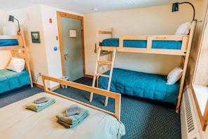 A dormitory room with bunk beds, a desk, and a chair. - Hike the Whites! Free Breakfast, Shared Bath, Hike/Ski trail Access (Bretton Woods)