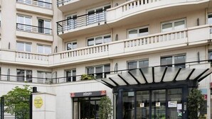 A multi-story building with a modern entrance, a sign for 'adagio,' and a 'RESIDENCE DE TOURISME' sign. - Paris Porte de Versailles -Metro (Issy-les-Moulineaux)