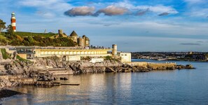 A coastal town with a lighthouse, historic buildings, and a bridge over the water. - Admiralty Retreat by Pureserviced (Plymouth)