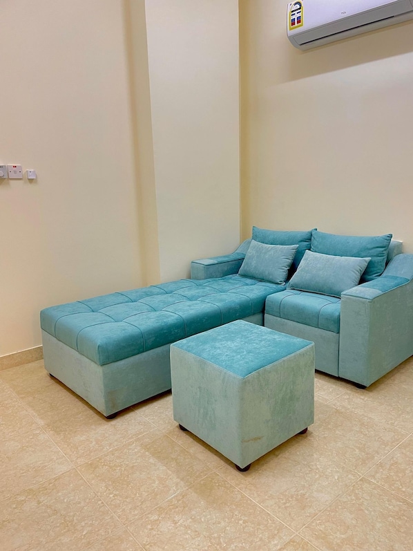 Deluxe Apartment | Living area | 70-inch Smart TV with digital channels - SUNSET HOTEL (Al Amarat)