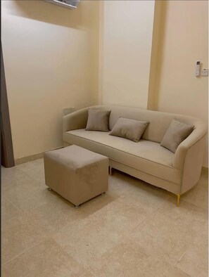 Deluxe Apartment | Living area | 70-inch Smart TV with digital channels