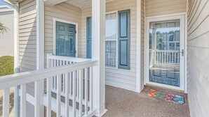 A house with a porch, a front door, and a set of windows. - 5 Mi to Shore: Condo w/ Patio in Sunset Beach! (Sunset Beach)