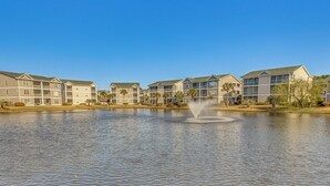 A row of modern multi-story buildings with a central water feature. - 5 Mi to Shore: Condo w/ Patio in Sunset Beach! (Sunset Beach)