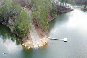 A river with a wooden dock extending into the water, surrounded by trees. - Sol & Luna: Luxury Cabin, Mountain Views, Hot Tub (Ellijay)
