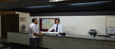 A reception desk with a sign above it reading "RECEPTION".