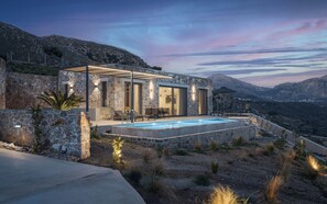 Enjoy panoramic views of the surrounding mountains from the villa's spacious outdoor area, featuring a swimming pool.