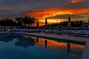 Seasonal outdoor pool, open 10:00 AM to 10:00 PM, pool umbrellas