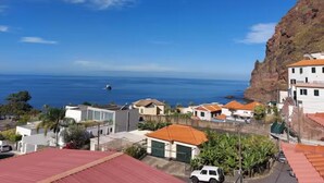 Une zone résidentielle côtière avec des maisons, une falaise et l’océan.