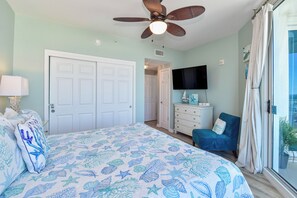 A bedroom with a bed, a ceiling fan, a TV, a dresser, and a window with curtains. - 12th Floor Condo w/ Family Friendly Amenities at The Palms of Destin! 🌴🌊 (Destin)