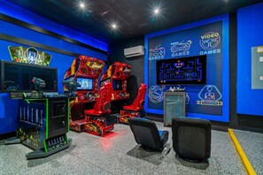 Ein Spielhallen-Bereich mit mehreren Rennsimulatoren, einer Neonreklame und dem Playzone-Logo.