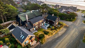 A coastal residential area with houses, a beach, and a road. - Left Coast Hideaway - New Listing! (Cannon Beach)