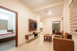 Deluxe Apartment | Living area | 32-inch LCD TV with digital channels