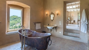 A bathroom with a vintage clawfoot tub, a sink, and a large mirror. - Col Di Casale - A breathtaking Umbrian villa in the green heart of Italy. (Pietralunga)
