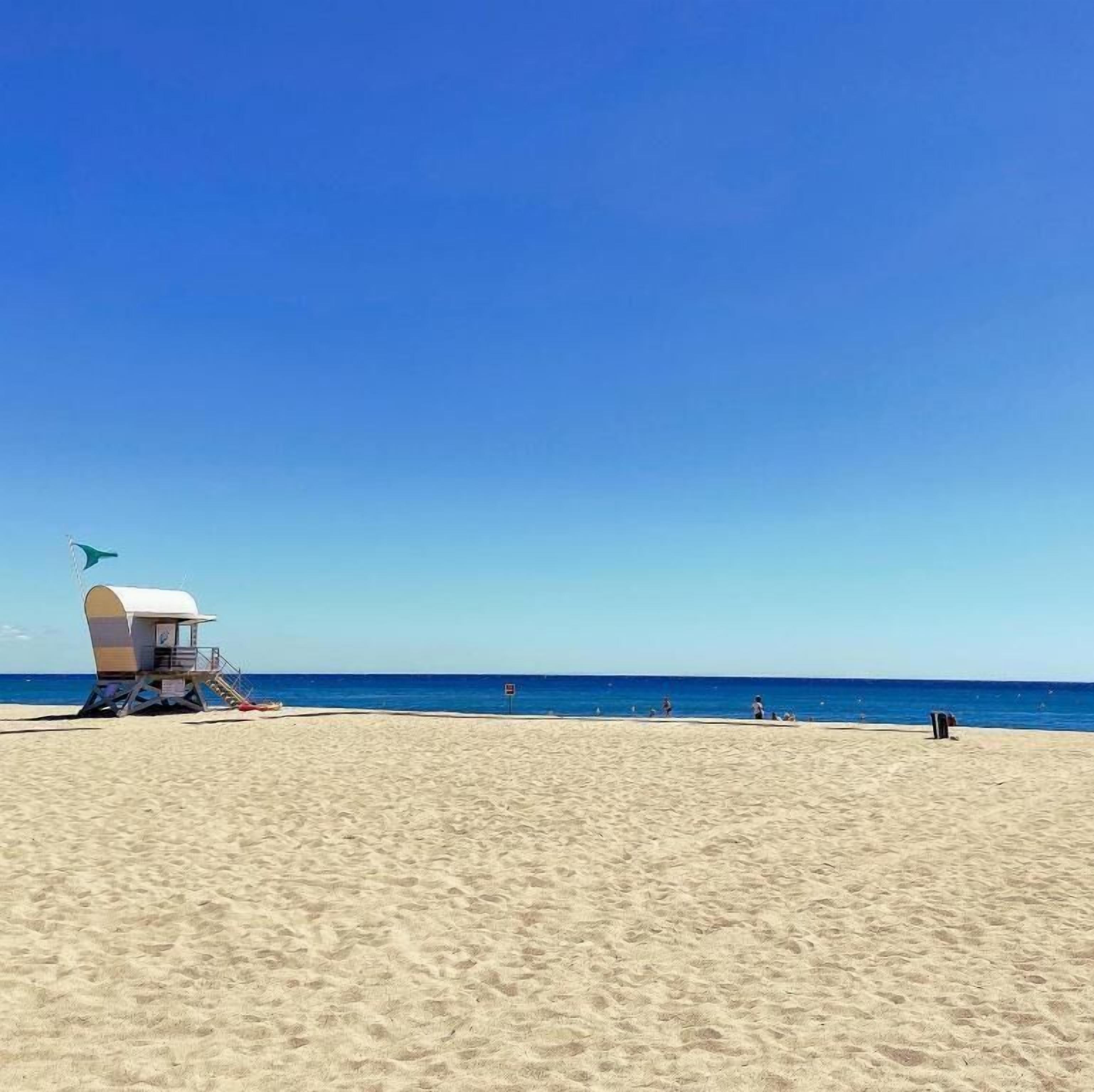 On the beach, sun-loungers, beach umbrellas, beach bar