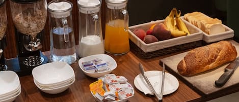 A breakfast buffet with various food items and beverages.