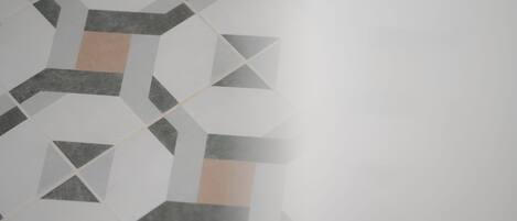 A geometric pattern on a tiled wall.