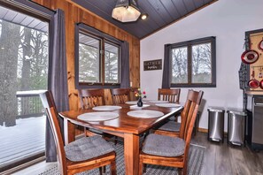 A wooden dining table with chairs, a chandelier, and a sign that says 'GATHER Together.' - Boulder Lakefront and Bike Trail Access (Boulder Junction)