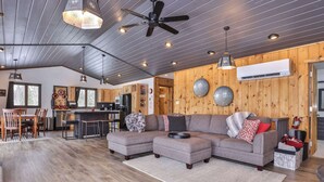 A spacious living area with a sectional sofa, dining table, and kitchen in the background. - Boulder Lakefront and Bike Trail Access (Boulder Junction)