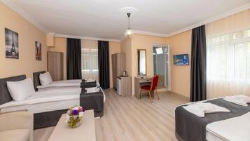 Standard Quadruple Room | Minibar, in-room safe, blackout curtains, soundproofing