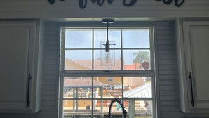 A room with a skylight, a window with a view of the outside, and a sign that says "be our guest". - Salty Waterways Escape with a dock. Family friendly, boat rental available  (Palm Coast)