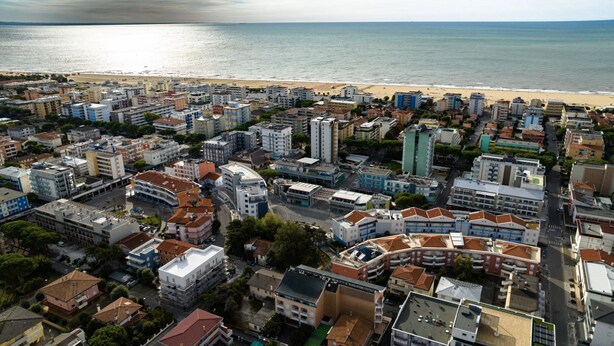 An aerial view of a coastal city with a beach in the background. - Beachside Getaway in Bibione (San Michele al Tagliamento)