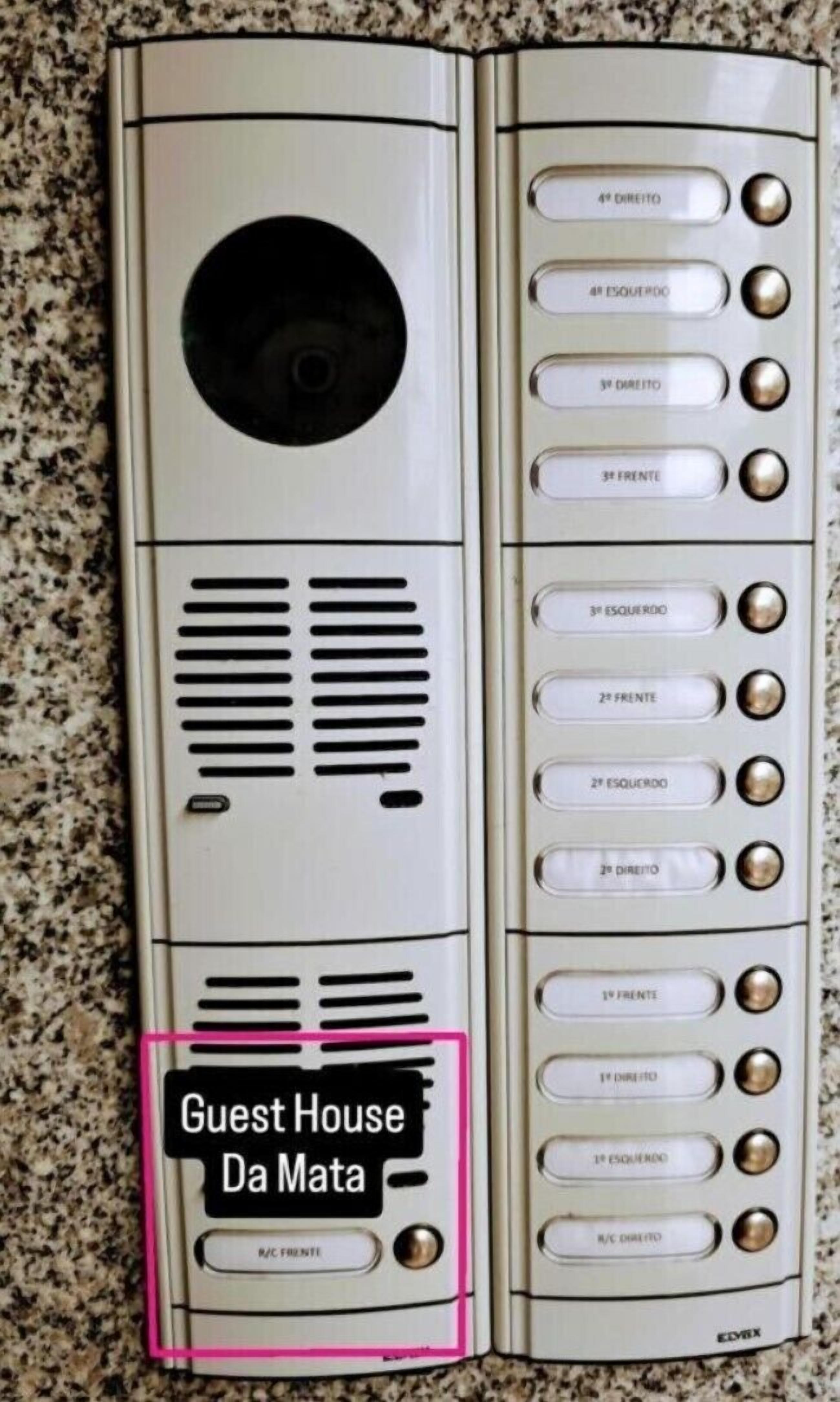 A control panel with multiple buttons labeled in a foreign language, likely for room service or hotel amenities.