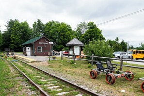 A train station with a small building labeled "Harley" and a covered waiting area.
