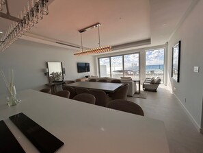 Enjoy ocean views from the spacious living area with a dining table, sofa, and flat-screen TV.