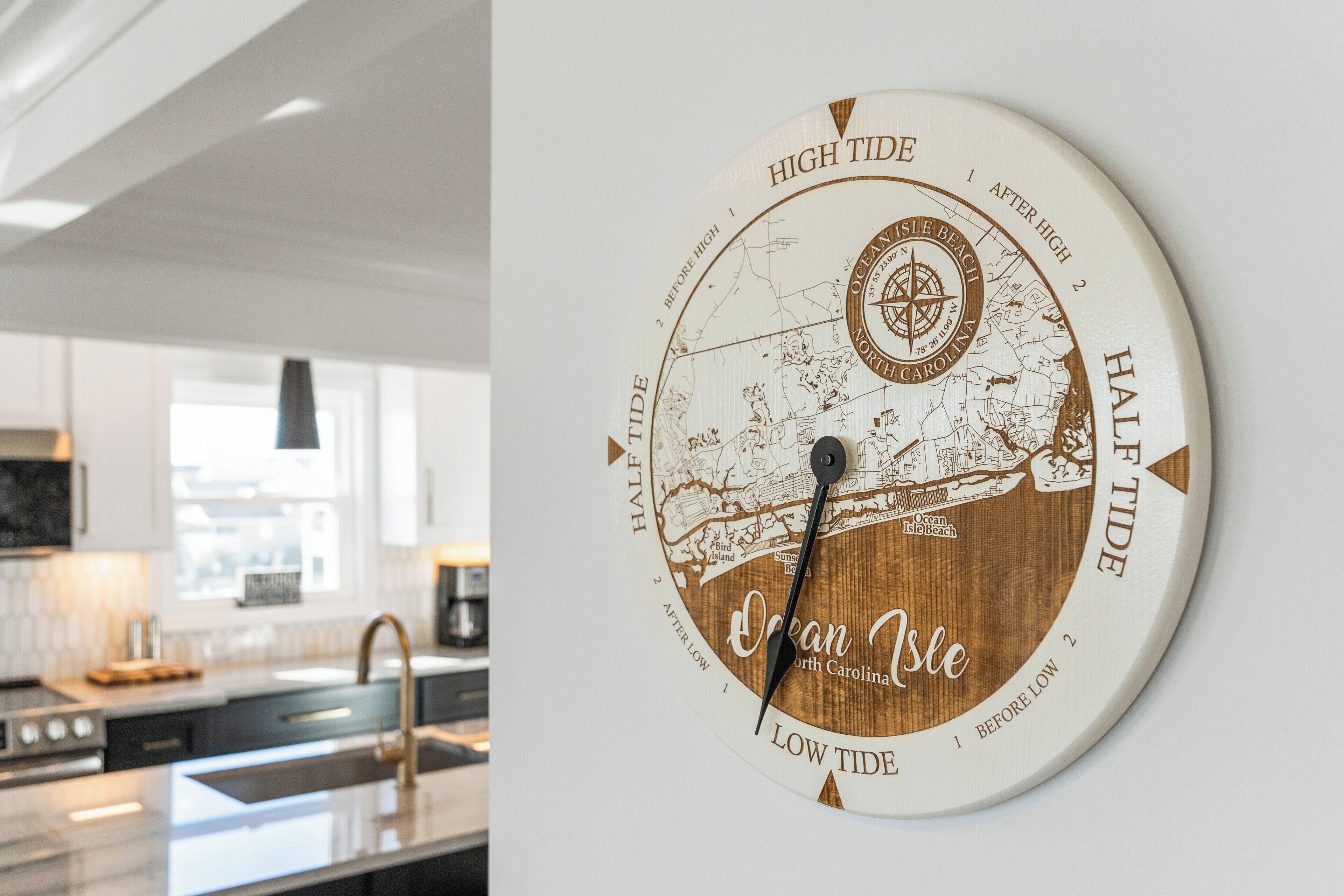 Een wandklok met een kaart van Ocean Isle, North Carolina, waarop eb en vloedtijden worden aangegeven.