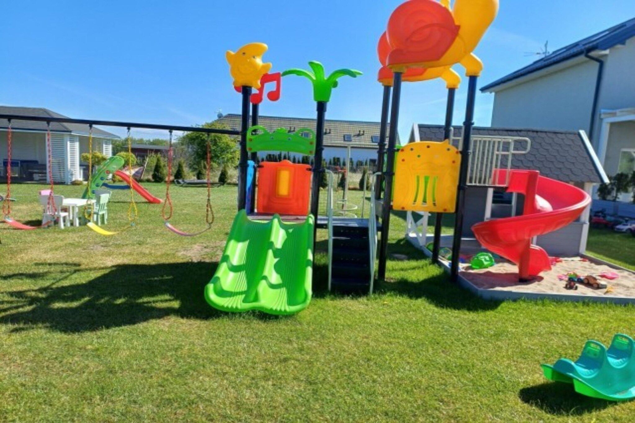 A playground with various play structures including slides and swings.
