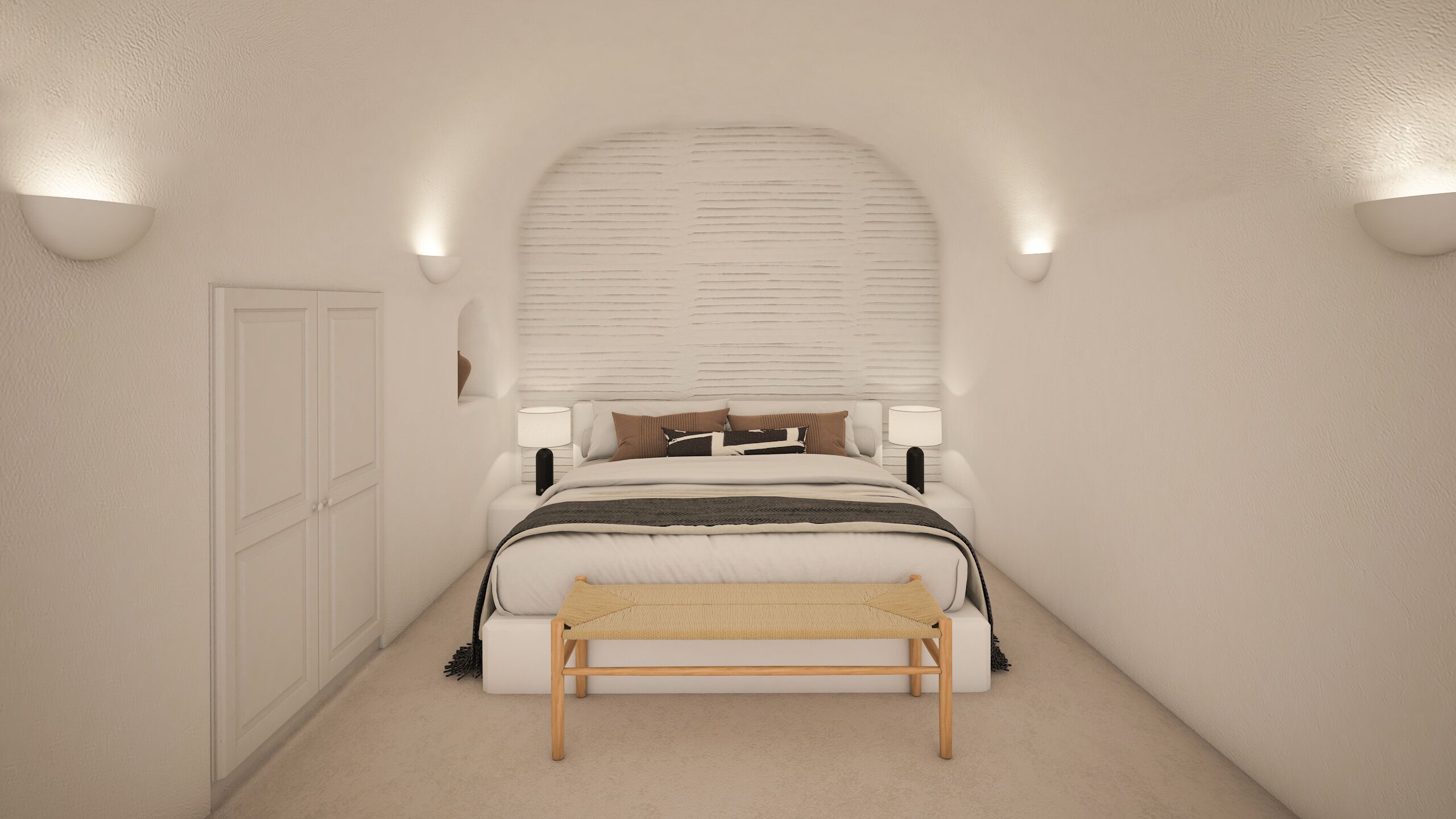A bedroom with a bed, bedside lamps, a bench, and a door.