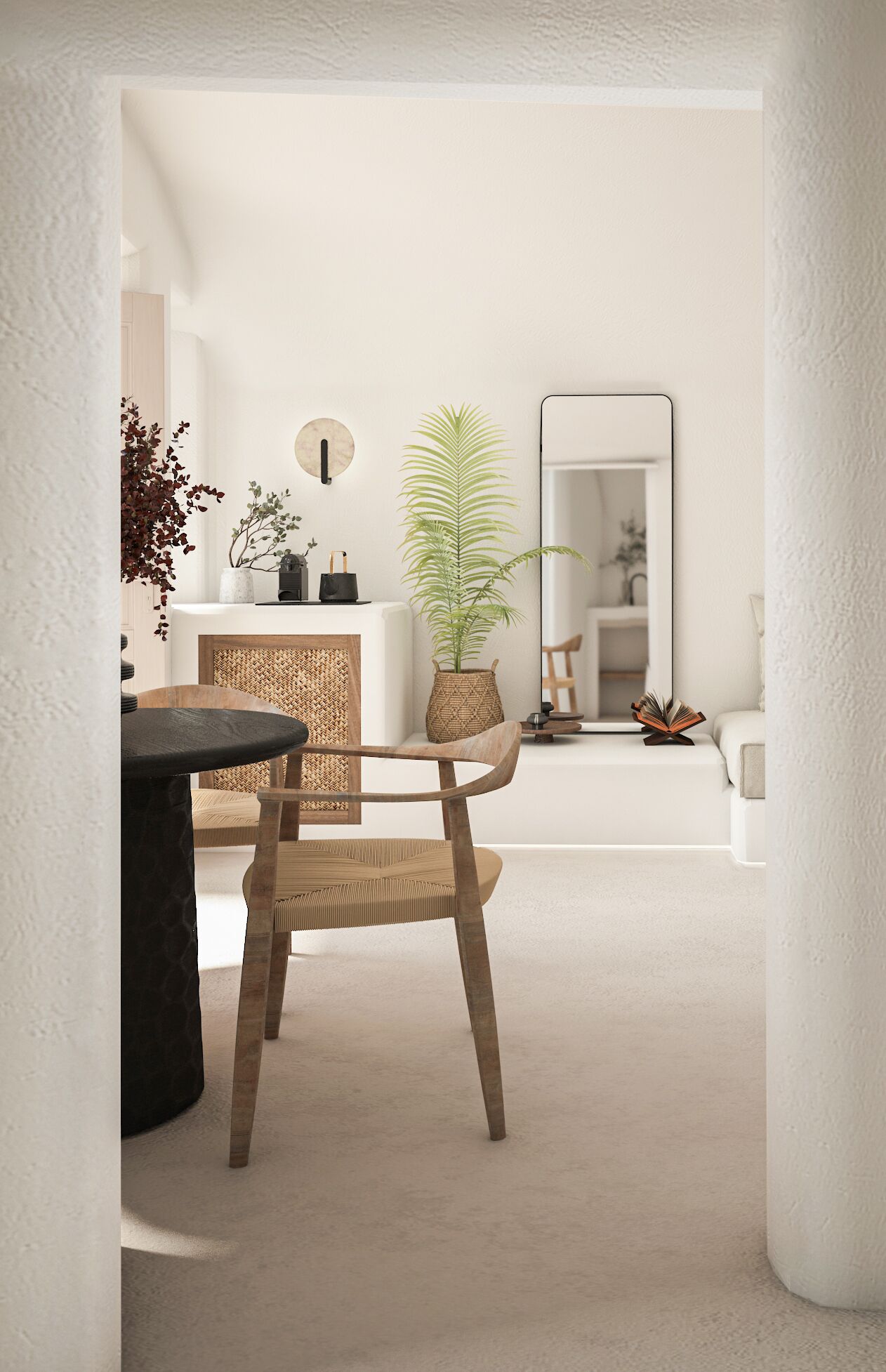 A modern living room with a round wooden dining table, a woven chair, and a large mirror on the wall.